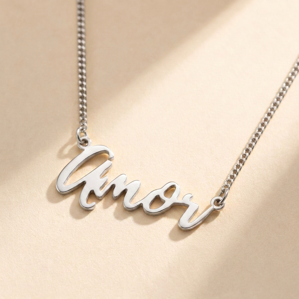 "Amor" Necklace hero photo - sterling silver script cutout pendant on cream background Anthology Jewelry