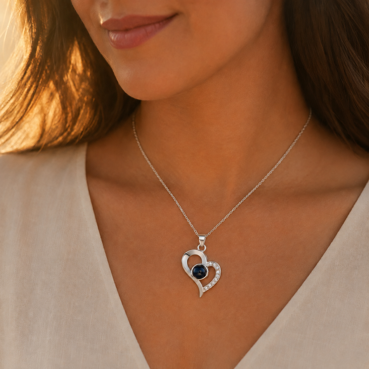 Silver heart locket style photo projection necklace lifestyle sunset - Anthology Jewelry