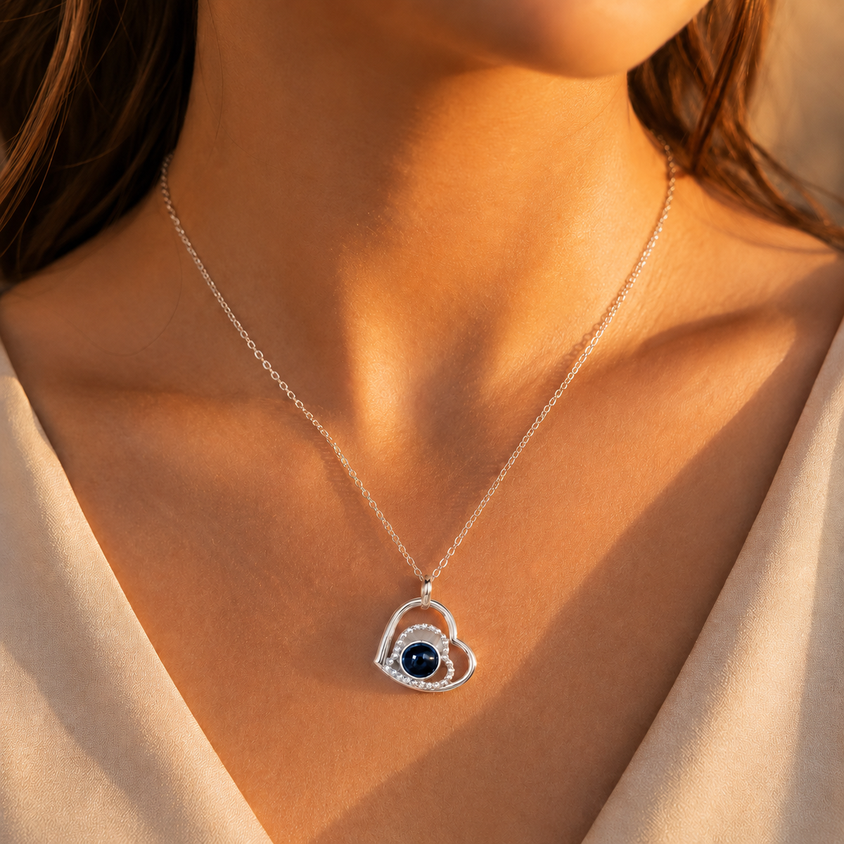 Silver teardrop infinity photo projection necklace lifestyle sunset - Anthology Jewelry