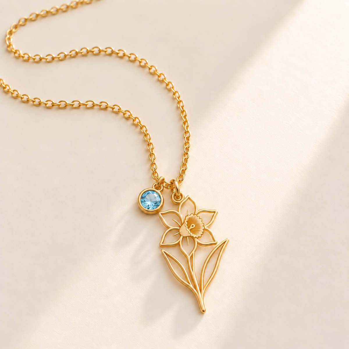 Custom Birth Flower & Birthstone Necklace hero photo - Gold December narcissus birth flower charm with Blue Topaz birthstone Anthology Jewelry