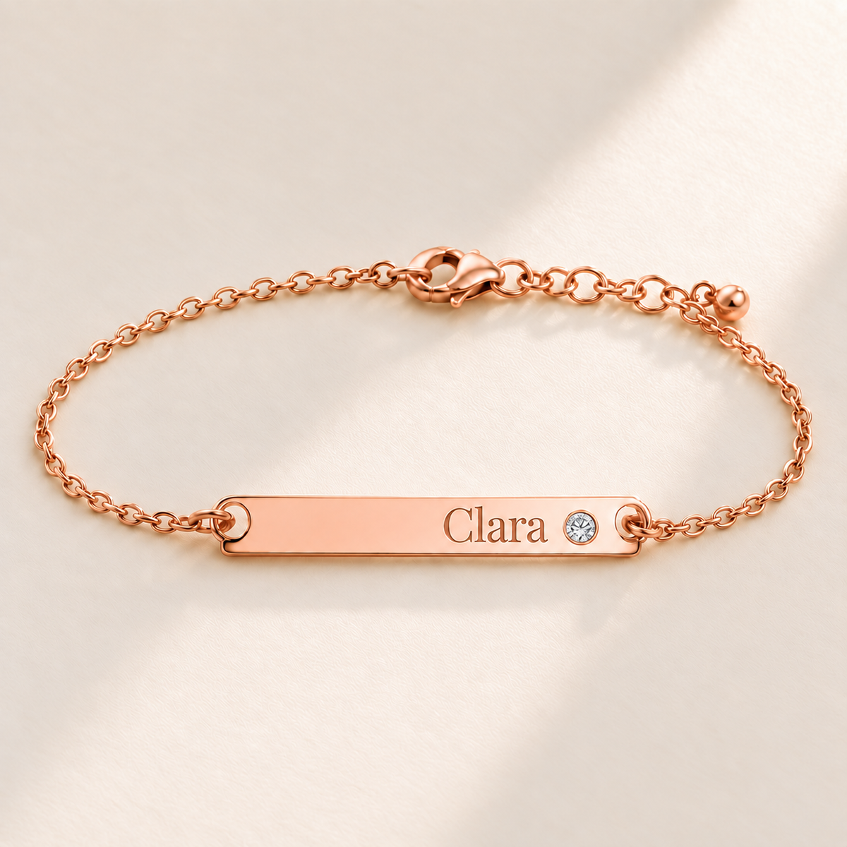 Birthstone Bar Bracelet hero photo - rose gold april diamond with Clara engraving in Playfair Display Anthology Jewelry