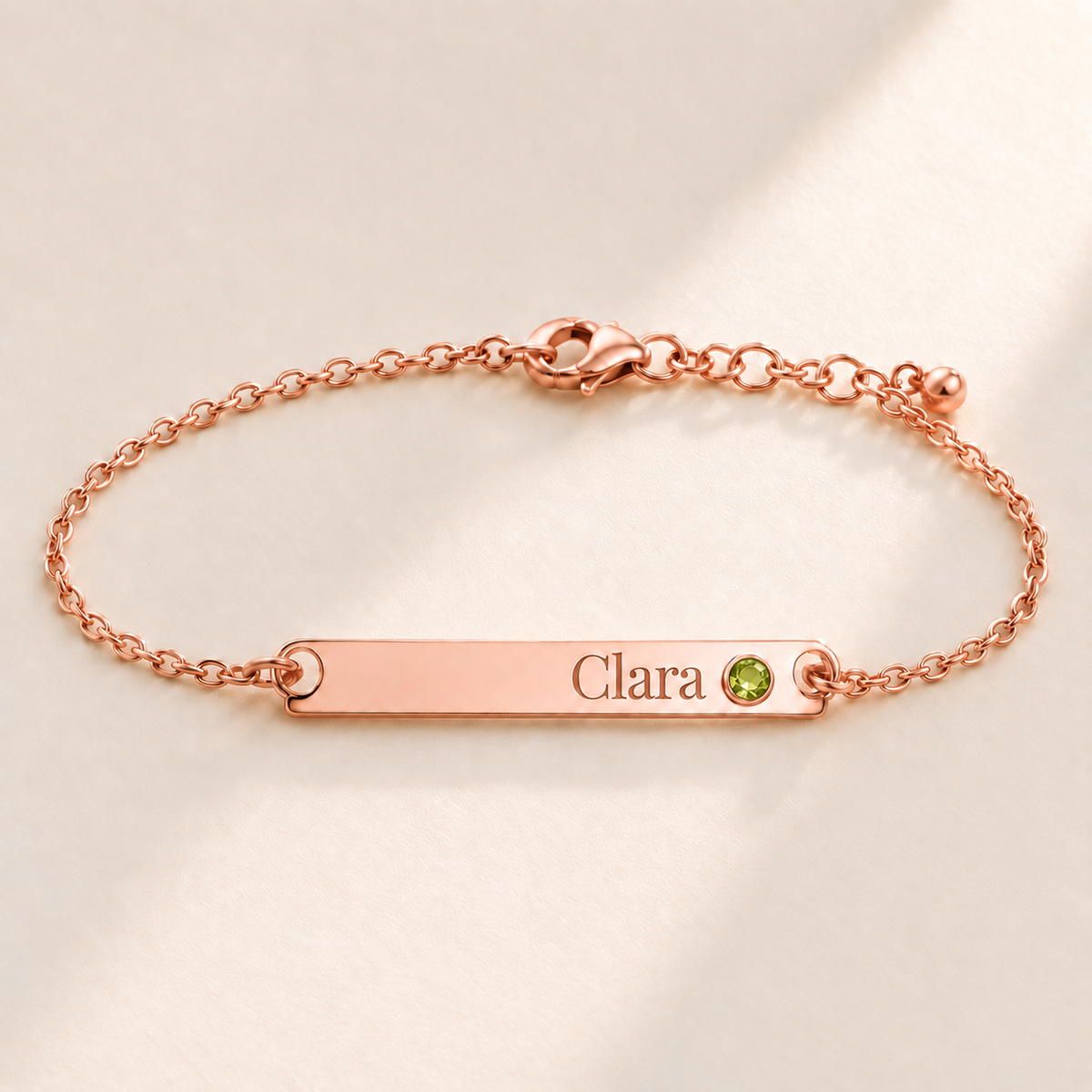 Birthstone Bar Bracelet hero photo - rose gold august peridot with Clara engraving in Playfair Display Anthology Jewelry