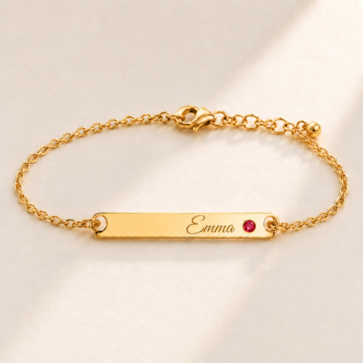 Birthstone Bar Bracelet hero photo - gold july ruby with Emma engraving in Great Vibes Anthology Jewelry