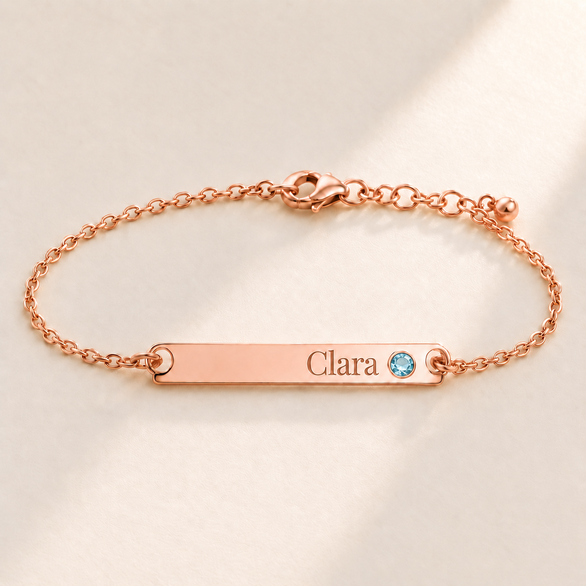 Birthstone Bar Bracelet hero photo - rose gold March aquamarine with Clara engraving in Playfair Display Anthology Jewelry