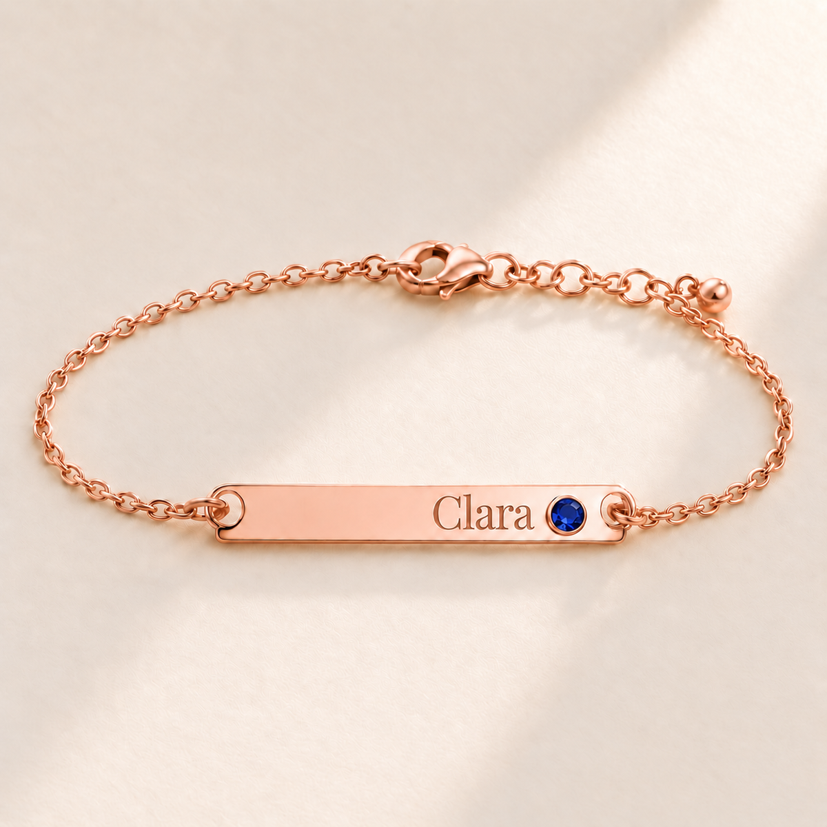 Birthstone Bar Bracelet hero photo - rose gold september sapphire with Clara engraving in Playfair Display Anthology Jewelry