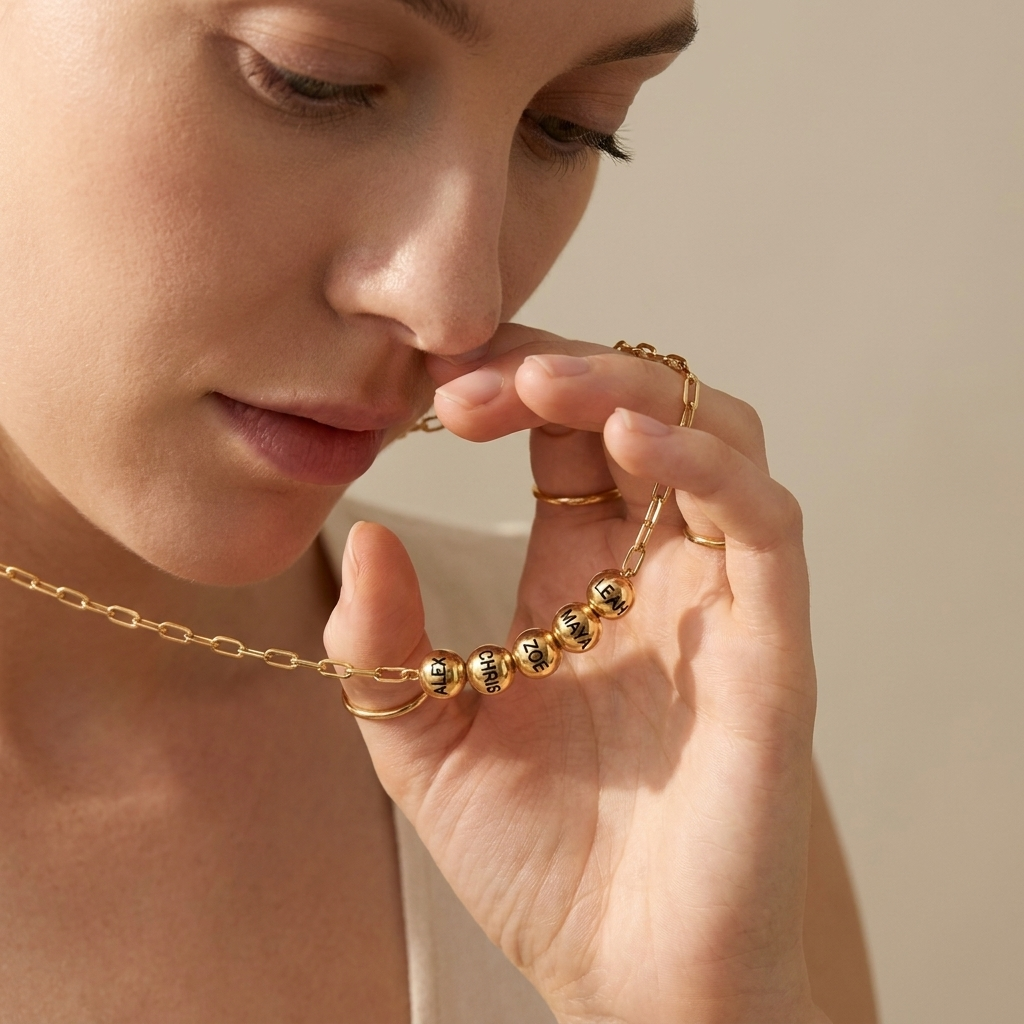 Custom Add-A-Bead Necklace lifestyle photo - woman holding gold name bead necklace in hand Anthology Jewelry
