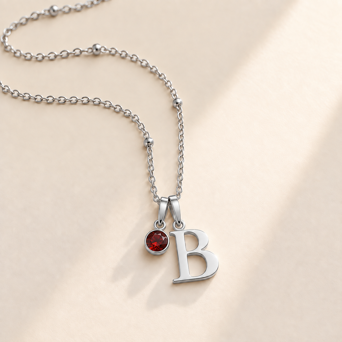 Custom Birthstone Initial Necklace hero silver photo - two separate bails with serif initial B and round birthstone Anthology Jewelry