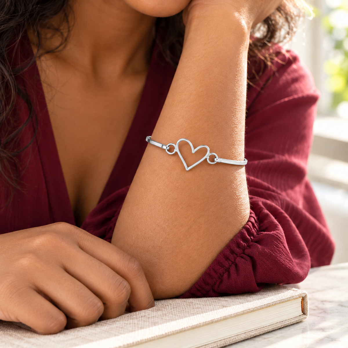 Custom Drawing Cuff Bracelet lifestyle photo - silver open-outline heart drawing on an adult woman's wrist Anthology Jewelry