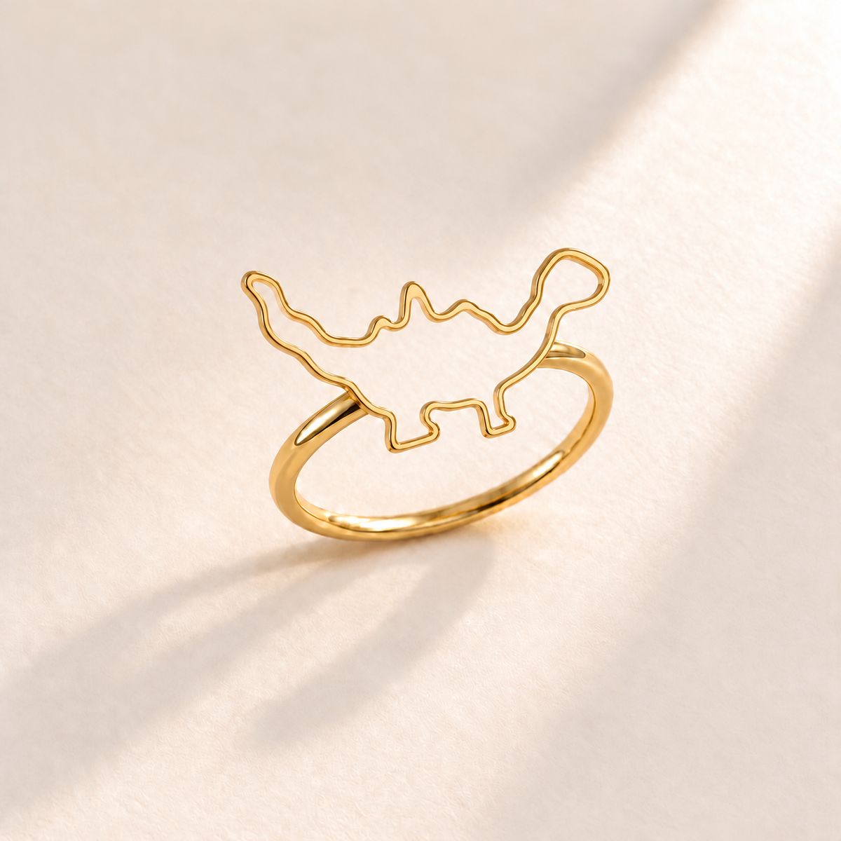 Custom Drawing Ring gold hero - open child-drawn dinosaur outline on a separate slim band, generated design concept Anthology Jewelry