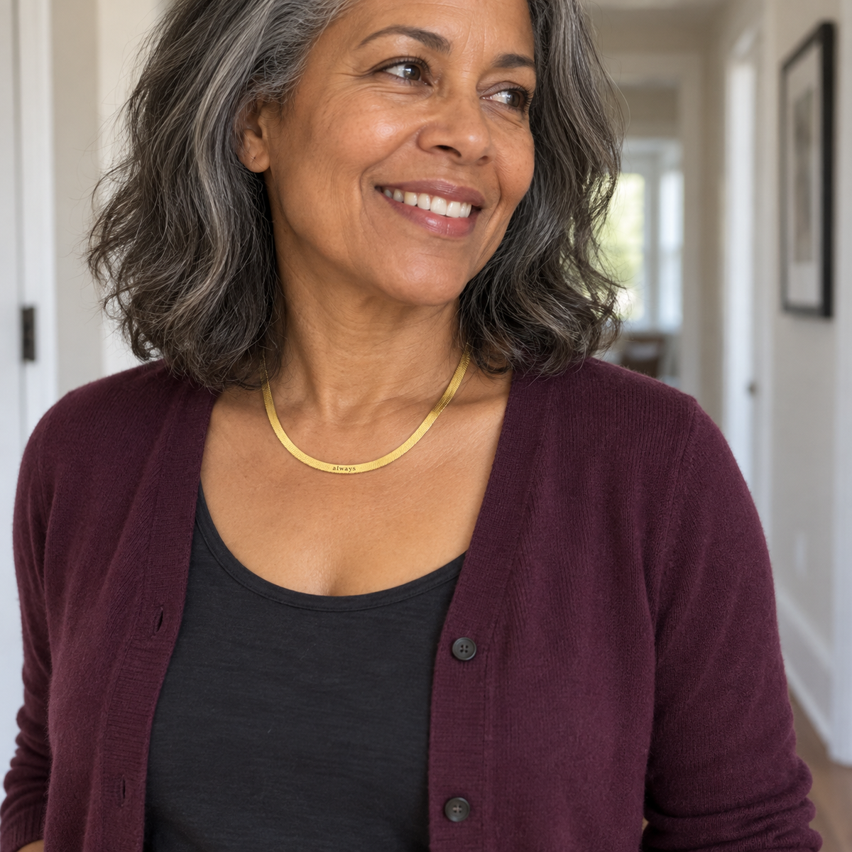 Custom Engraved Herringbone Necklace lifestyle 2 photo - woman wearing necklace in hallway Anthology Jewelry