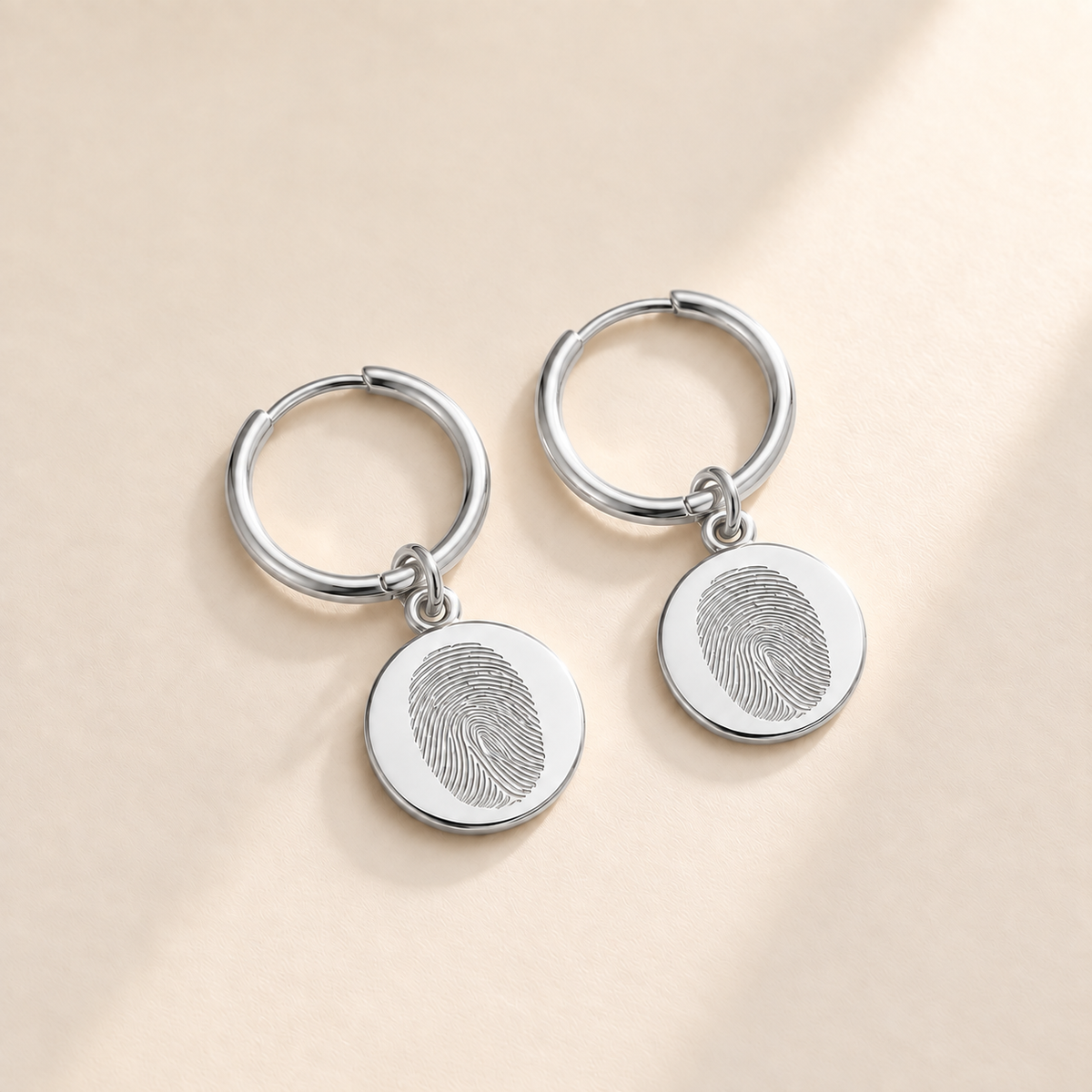 Custom Fingerprint Huggie Hoop Earrings hero photo - silver fingerprint disc huggie earrings Anthology Jewelry