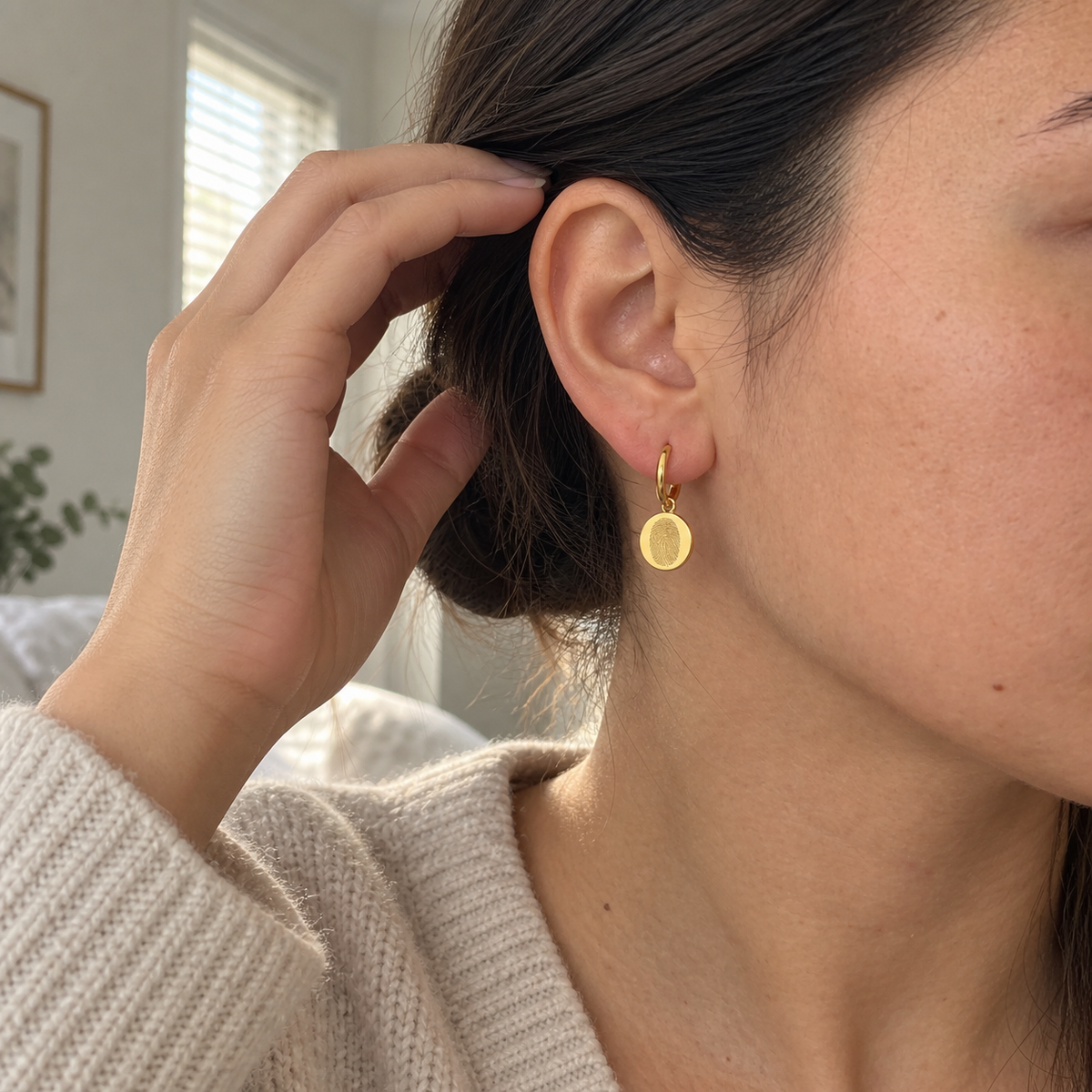 Custom Fingerprint Huggie Hoop Earrings UGC photo - candid closeup wearing gold fingerprint earring Anthology Jewelry