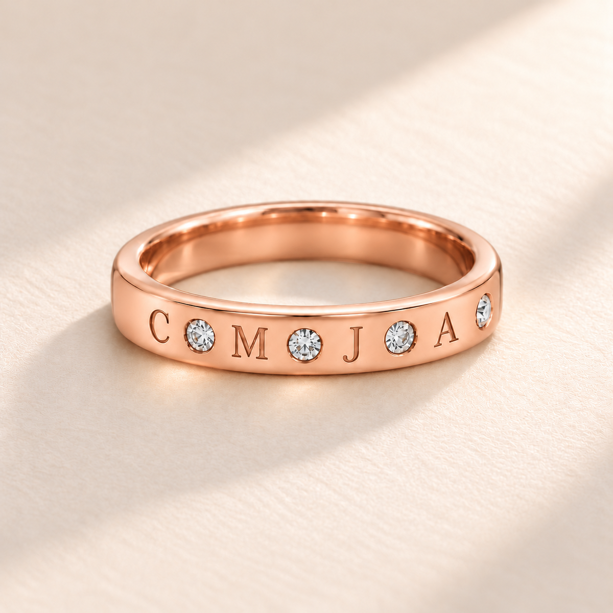 Rose gold flush stone initial band with four engraved initials C M J A