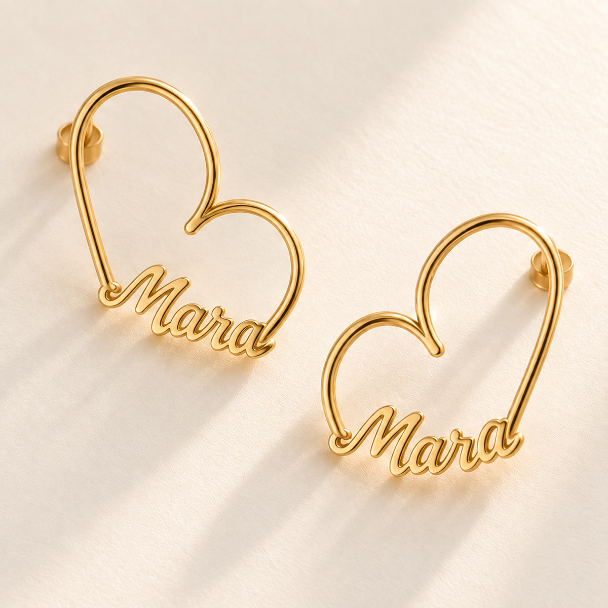 Custom Heart-Frame Name Stud Earrings close product detail of the open heart wire and Mara name - Anthology Jewelry