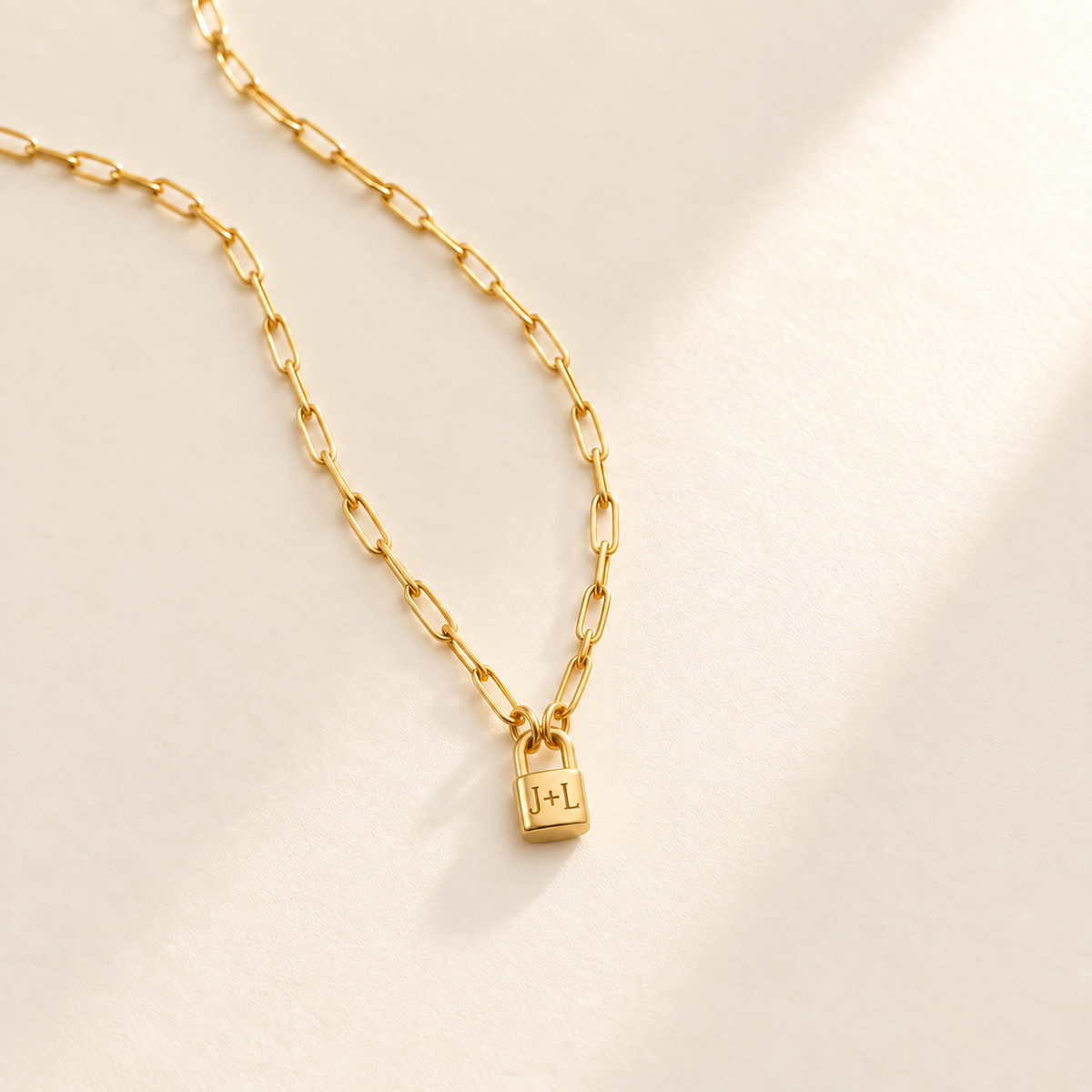 Custom Initial Lock Necklace hero photo - tiny closed padlock on paperclip chain Anthology Jewelry