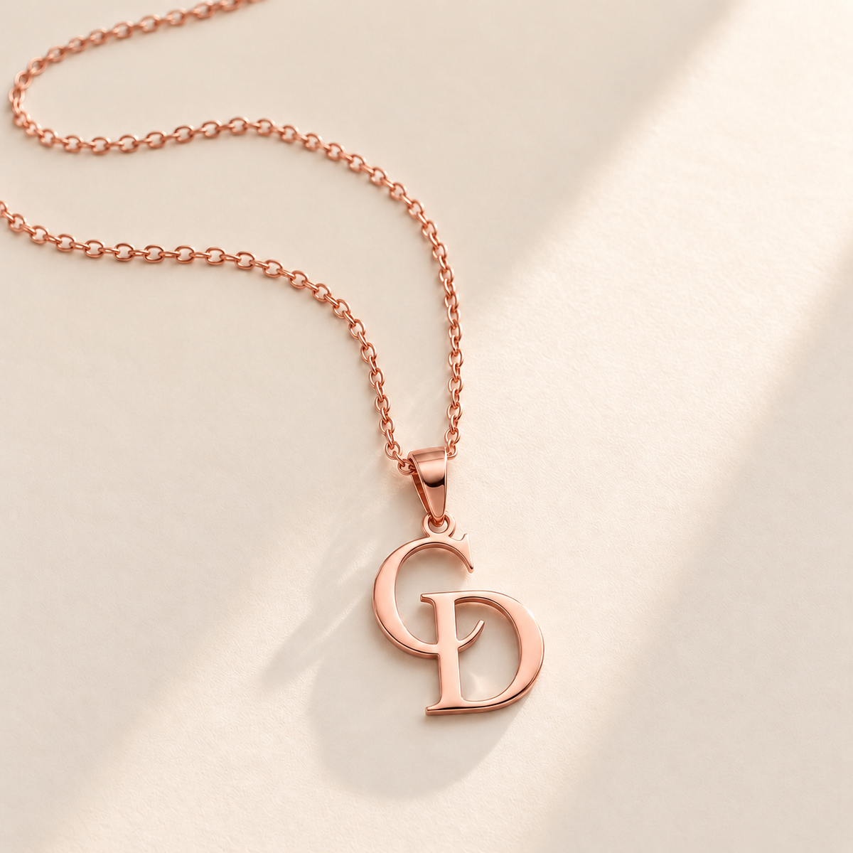 Custom Overlapping Initials Necklace rose gold hero photo - rose gold C and D serif initials pendant on a fine cable chain Anthology Jewelry
