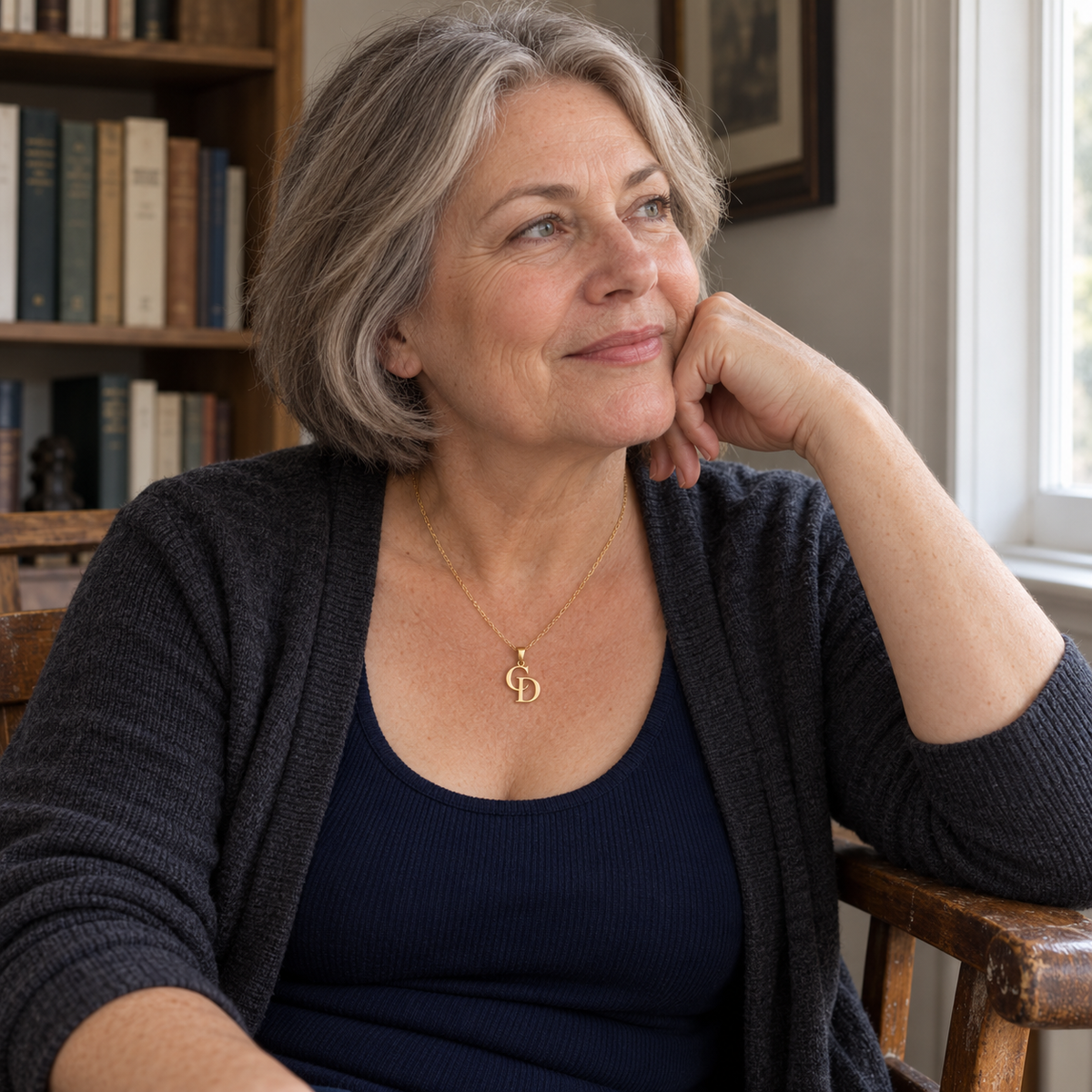 Custom Overlapping Initials Necklace lifestyle photo - gold C and D pendant worn by a seated gray-haired model Anthology Jewelry