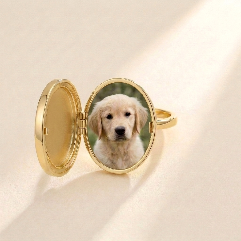 Custom Photo Locket Ring detail photo - gold oval hinged locket ring opened to reveal a personal puppy photo in a thin gold frame Anthology Jewelry