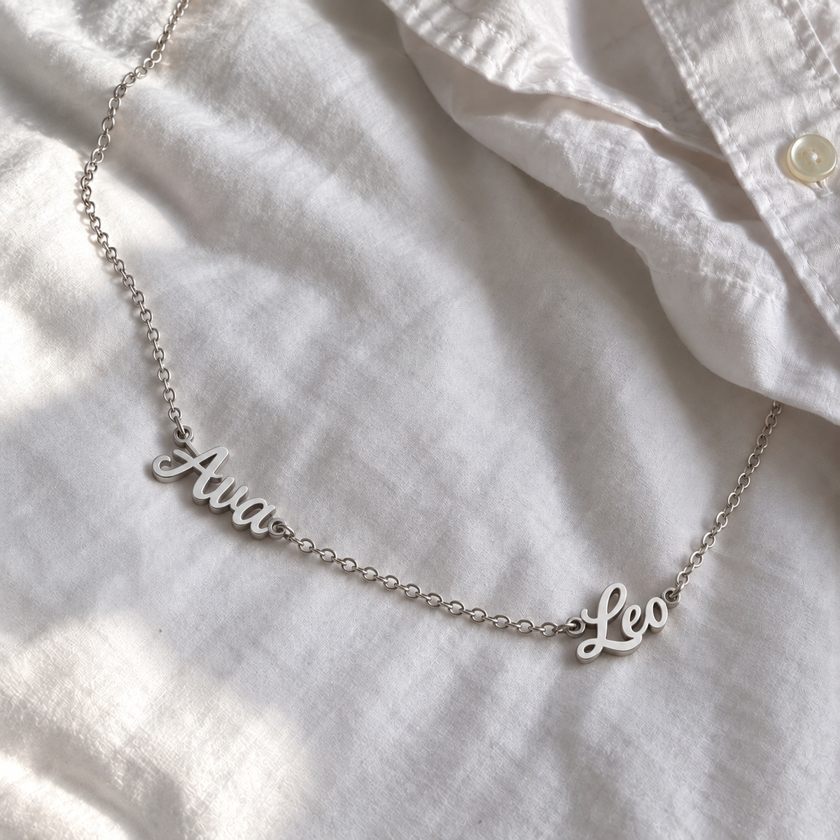 Custom Spaced Names Necklace UGC-style photo - silver finish with Ava / Leo personalization Anthology Jewelry