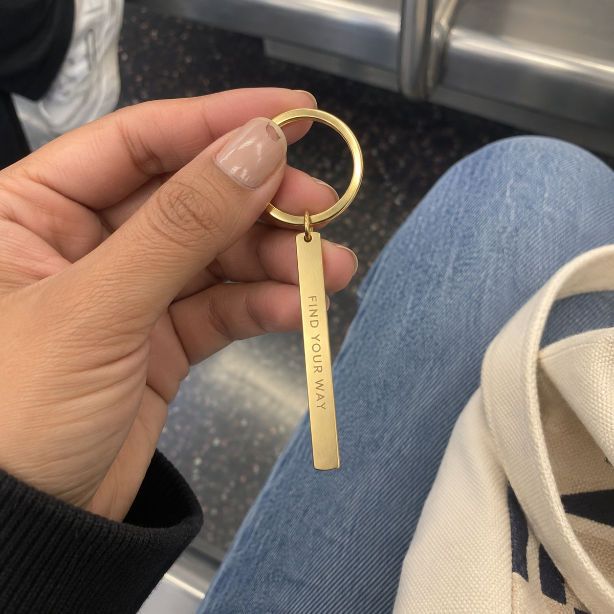 Casual transit phone photo of a custom vertical bar keychain