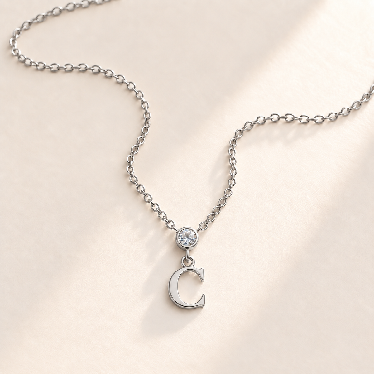 Custom Vertical Birthstone Initial Necklace april silver birthstone photo - round inline stone with hanging serif C Anthology Jewelry
