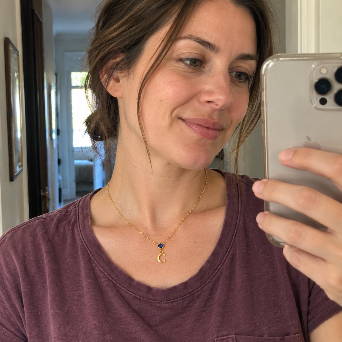 Casual mirror photo showing vertical birthstone initial necklace