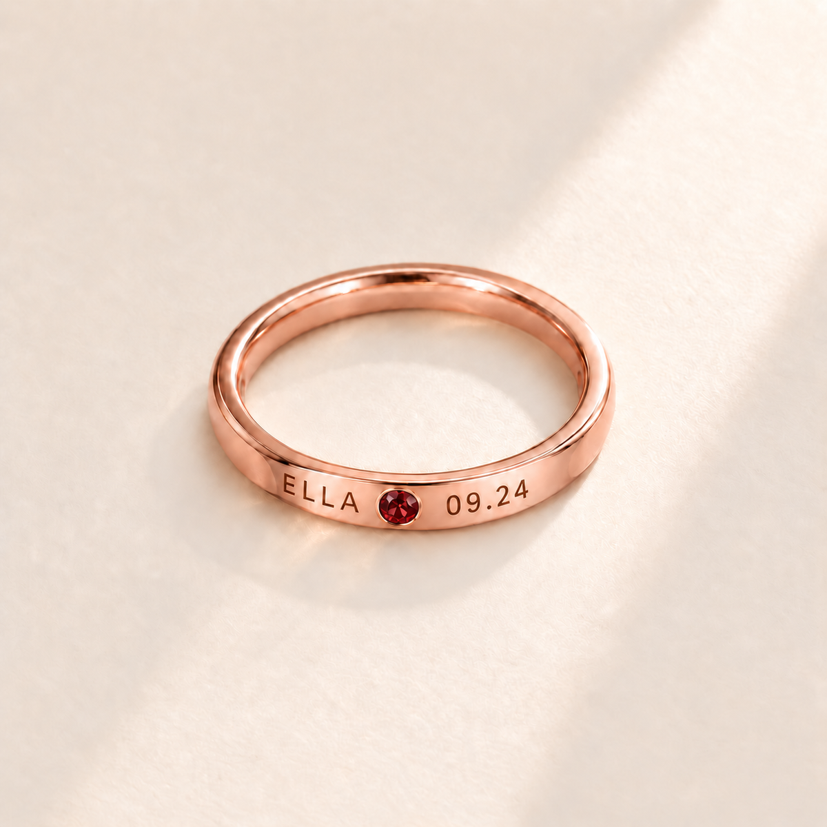 Custom Date & Name Birthstone Stacking Ring, January Garnet, Rose Gold finish. Illustrative product rendering; natural gemstone colors may vary.