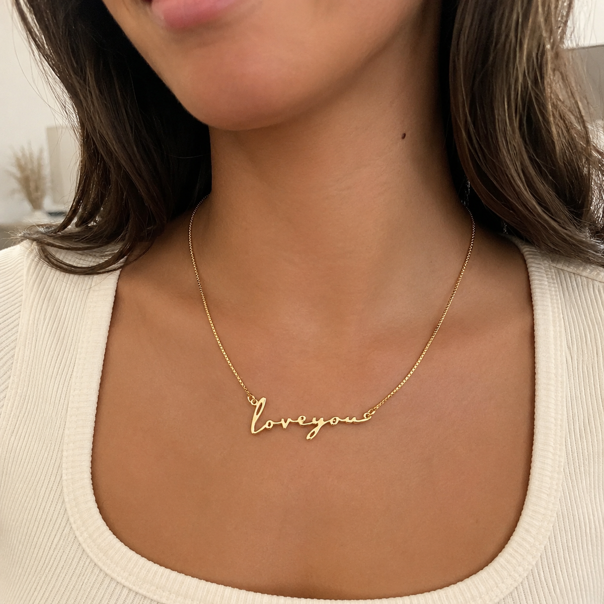 "Loveyou" Necklace detail photo - alternate angle of polished gold script lettering Anthology Jewelry