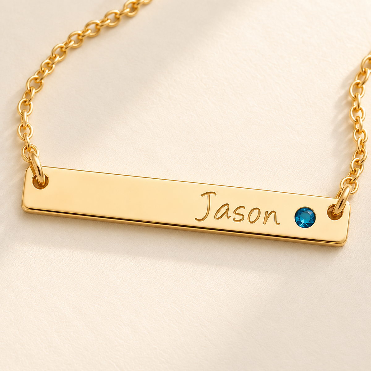 Personalized Bar Necklace with Birthstone detail photo - close view of gold engraving and blue birthstone Anthology Jewelry