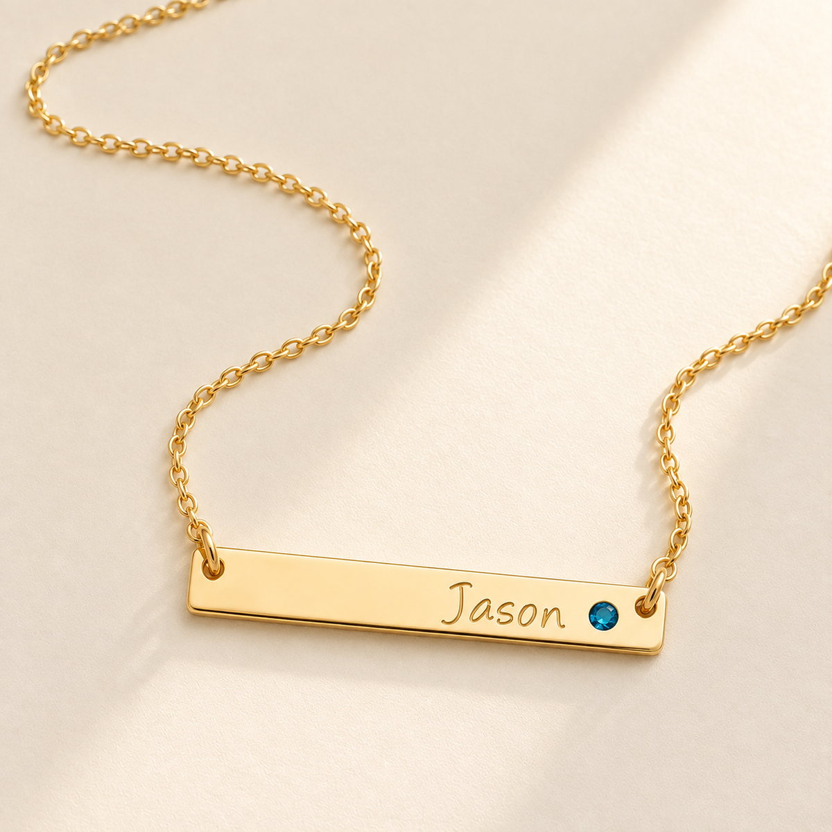 Personalized Bar Necklace with Birthstone hero photo - gold necklace with Jason engraving and blue birthstone Anthology Jewelry