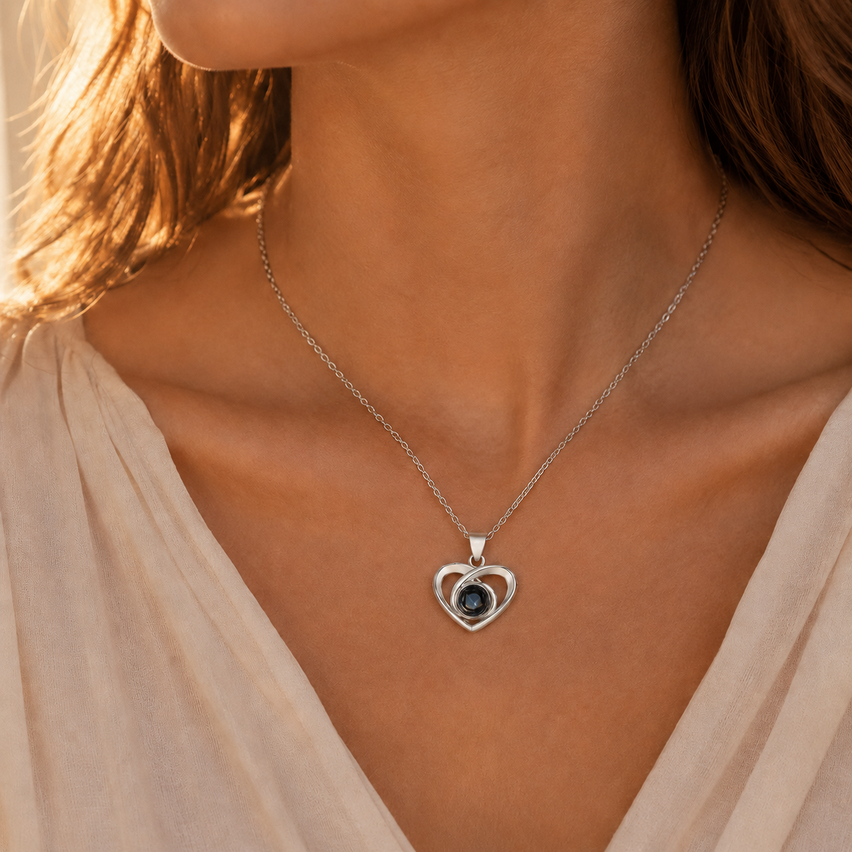 Silver swirl knot photo projection necklace lifestyle sunset - Anthology Jewelry