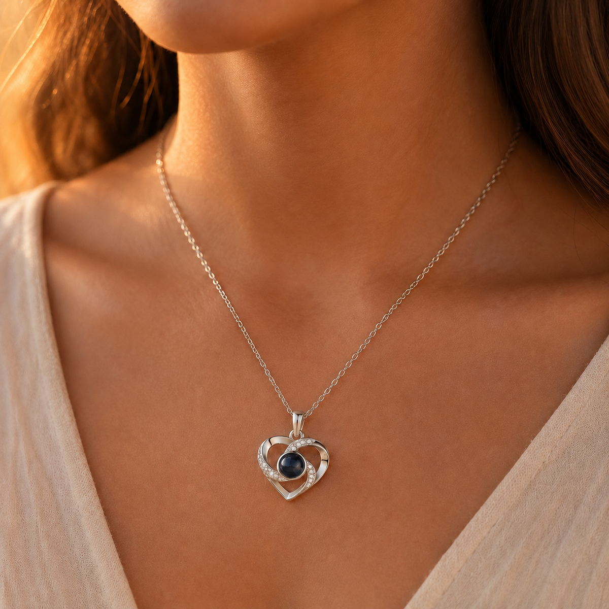 Silver swirled heart photo projection necklace lifestyle sunset - Anthology Jewelry