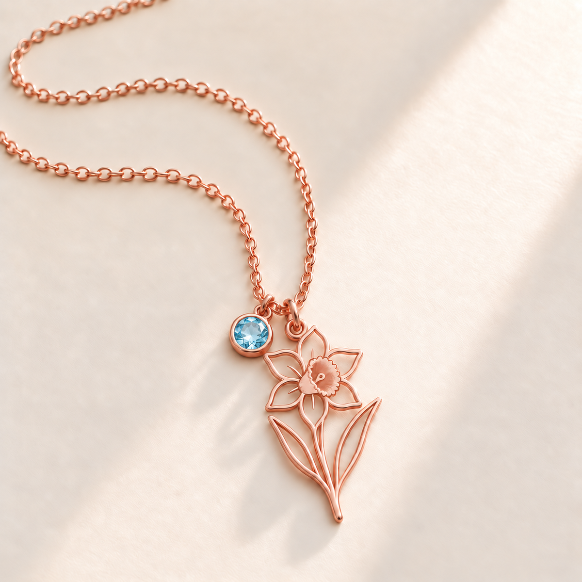Custom Birth Flower & Birthstone Necklace hero photo - Rose Gold December narcissus birth flower charm with Blue Topaz birthstone Anthology Jewelry