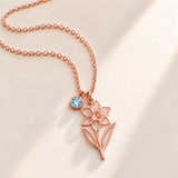 Custom Birth Flower & Birthstone Necklace hero photo - Rose Gold December narcissus birth flower charm with Blue Topaz birthstone Anthology Jewelry