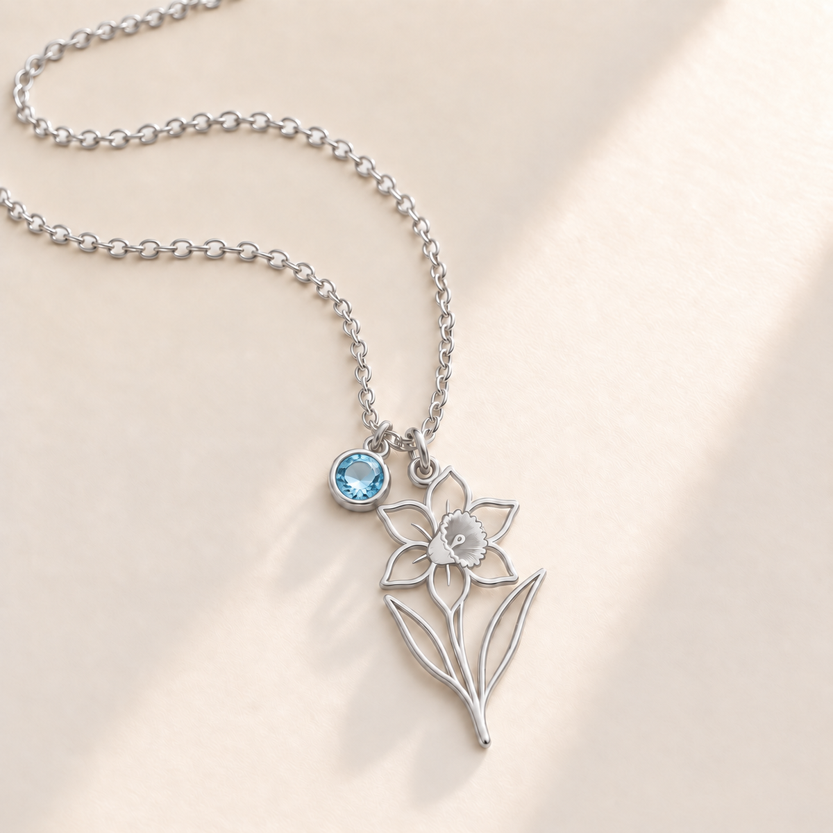 Custom Birth Flower & Birthstone Necklace hero photo - Silver December narcissus birth flower charm with Blue Topaz birthstone Anthology Jewelry