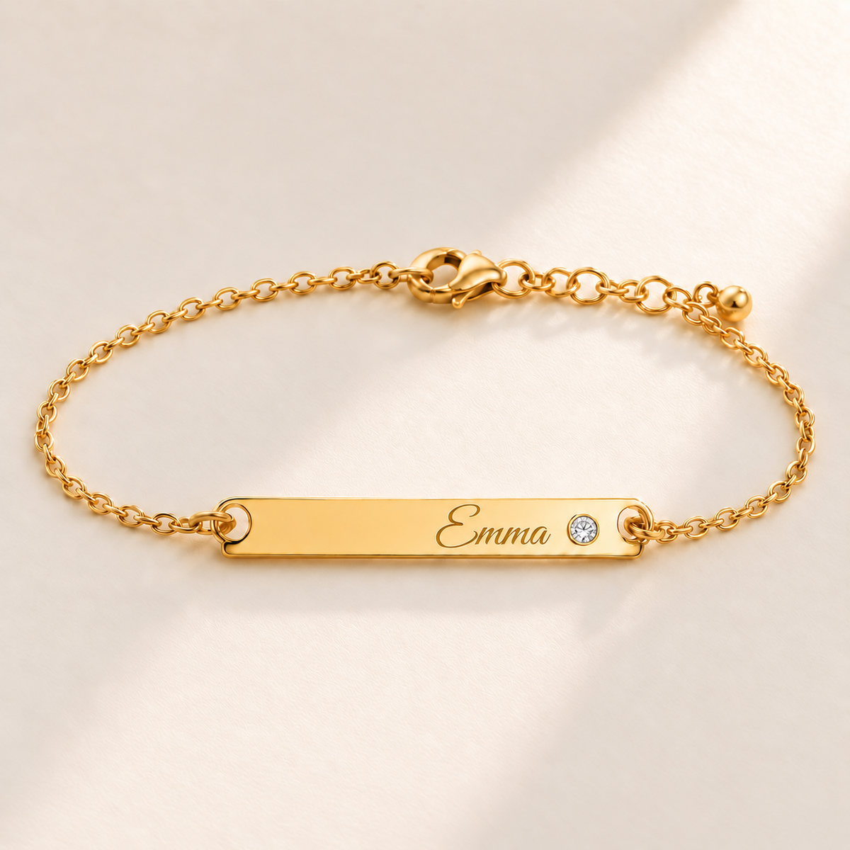 Birthstone Bar Bracelet hero photo - gold april diamond with Emma engraving in Great Vibes Anthology Jewelry