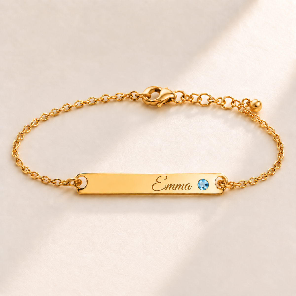 Birthstone Bar Bracelet hero photo - gold december blue topaz with Emma engraving in Great Vibes Anthology Jewelry