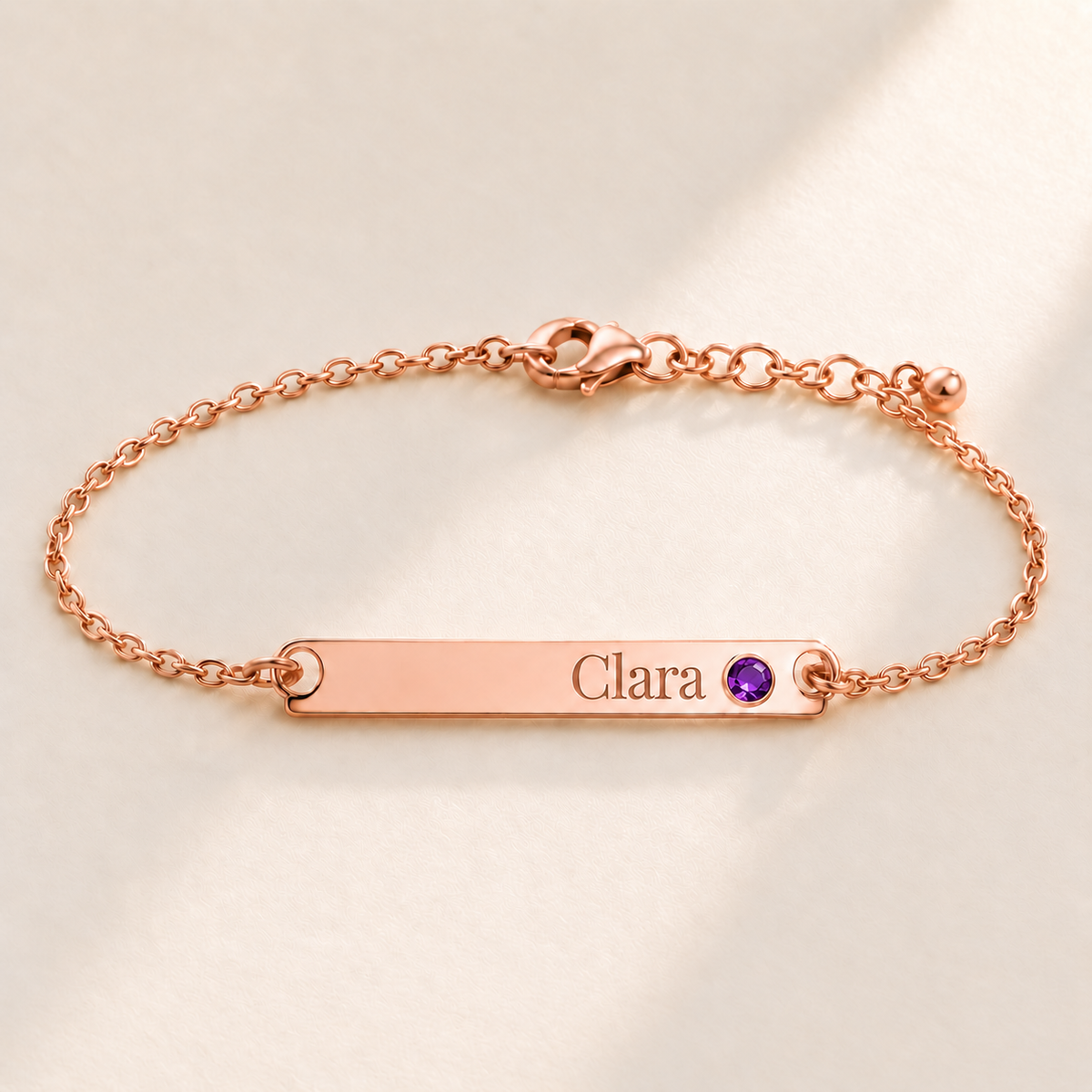Birthstone Bar Bracelet hero photo - rose gold february amethyst with Clara engraving in Playfair Display Anthology Jewelry