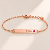 Birthstone Bar Bracelet hero photo - rose gold july ruby with Clara engraving in Playfair Display Anthology Jewelry