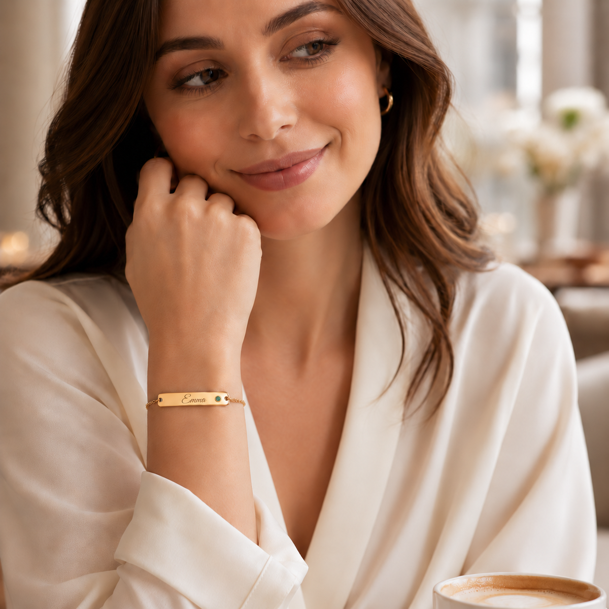 Birthstone Bar Bracelet lifestyle photo - gold Emma engraving and smaller round green gemstone Anthology Jewelry