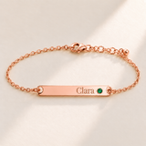 Birthstone Bar Bracelet hero photo - rose gold may emerald with Clara engraving in Playfair Display Anthology Jewelry