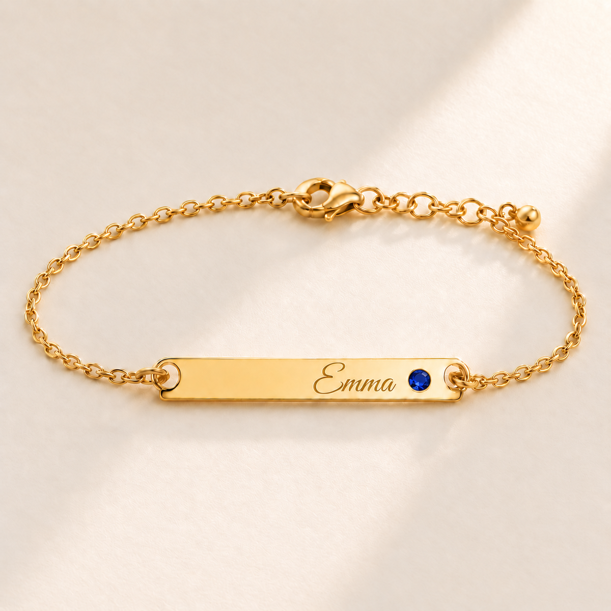 Birthstone Bar Bracelet hero photo - gold september sapphire with Emma engraving in Great Vibes Anthology Jewelry