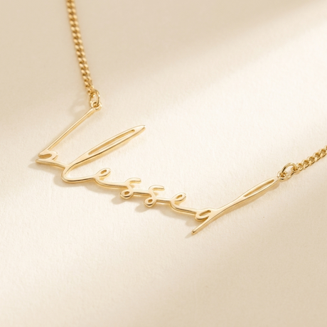 "Blessed" Necklace detail photo - close-up of delicate gold script lettering Anthology Jewelry