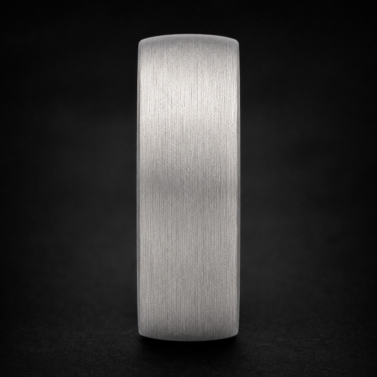 Macro glamour shot of a brushed tungsten two-toned ring with dramatic lighting - Anthology Jewelry