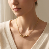Custom Add-A-Bead Necklace lifestyle photo - woman wearing gold name bead necklace at the collarbone Anthology Jewelry