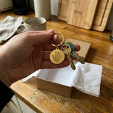 Custom Baby Handprint or Footprint Keychain UGC photo - gold handprint keychain just unwrapped from gift box Anthology Jewelry