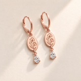 Custom Birth Flower & Birthstone Drop Earrings april rose gold hero photo - engraved two sweet-pea flowers, small bud and two leaves with clear colorless pear stones Anthology Jewelry