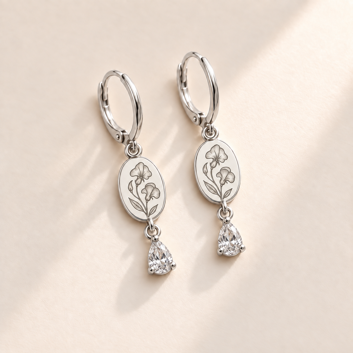 Custom Birth Flower & Birthstone Drop Earrings april silver hero photo - engraved two sweet-pea flowers, small bud and two leaves with clear colorless pear stones Anthology Jewelry