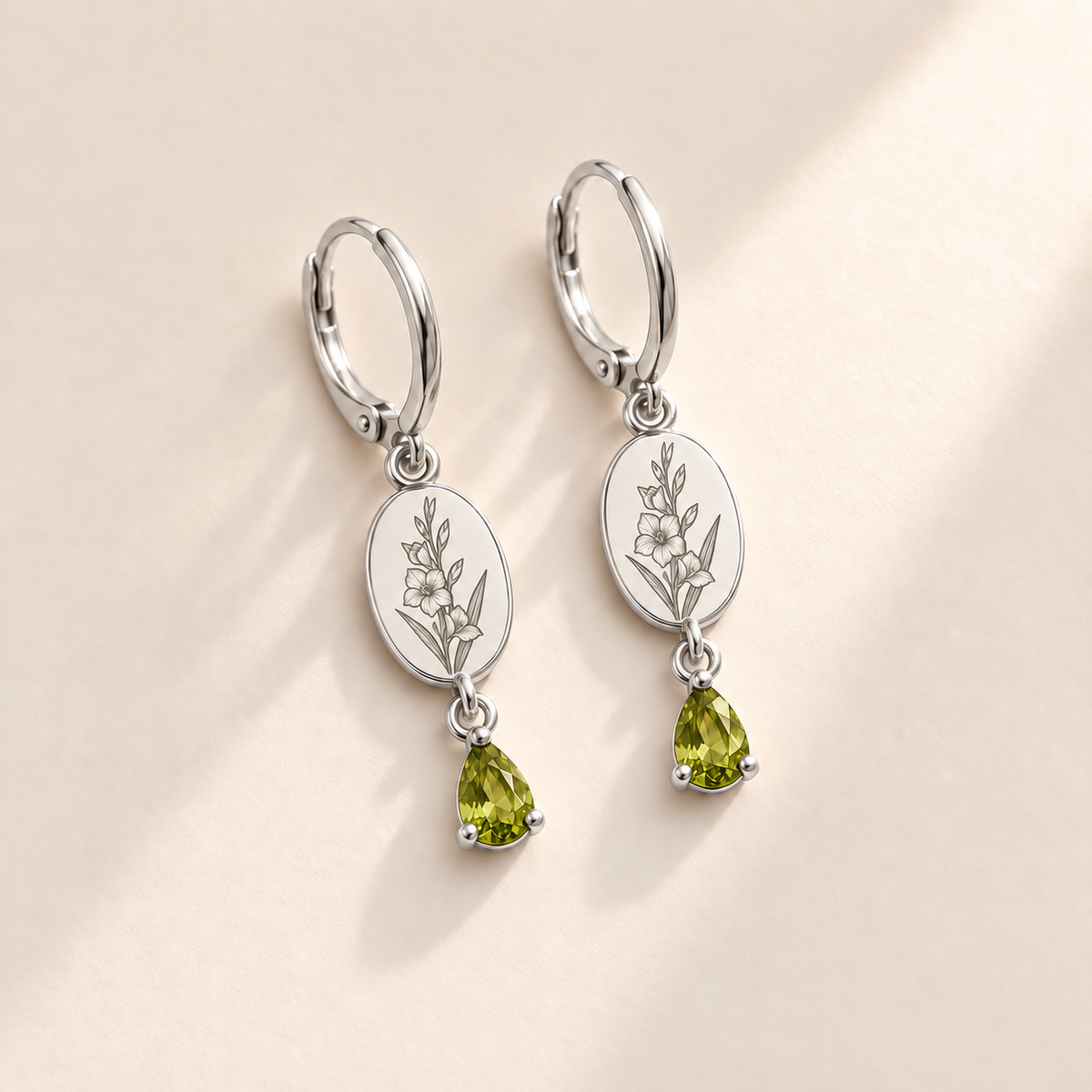 Custom Birth Flower & Birthstone Drop Earrings august silver hero photo - engraved gladiolus stem with multiple flowers and buds and long pointed leaves with yellow-green peridot pear stones Anthology Jewelry