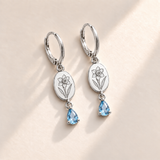 Custom Birth Flower & Birthstone Drop Earrings December silver hero photo - narcissus engraving and faceted blue topaz pear stones Anthology Jewelry